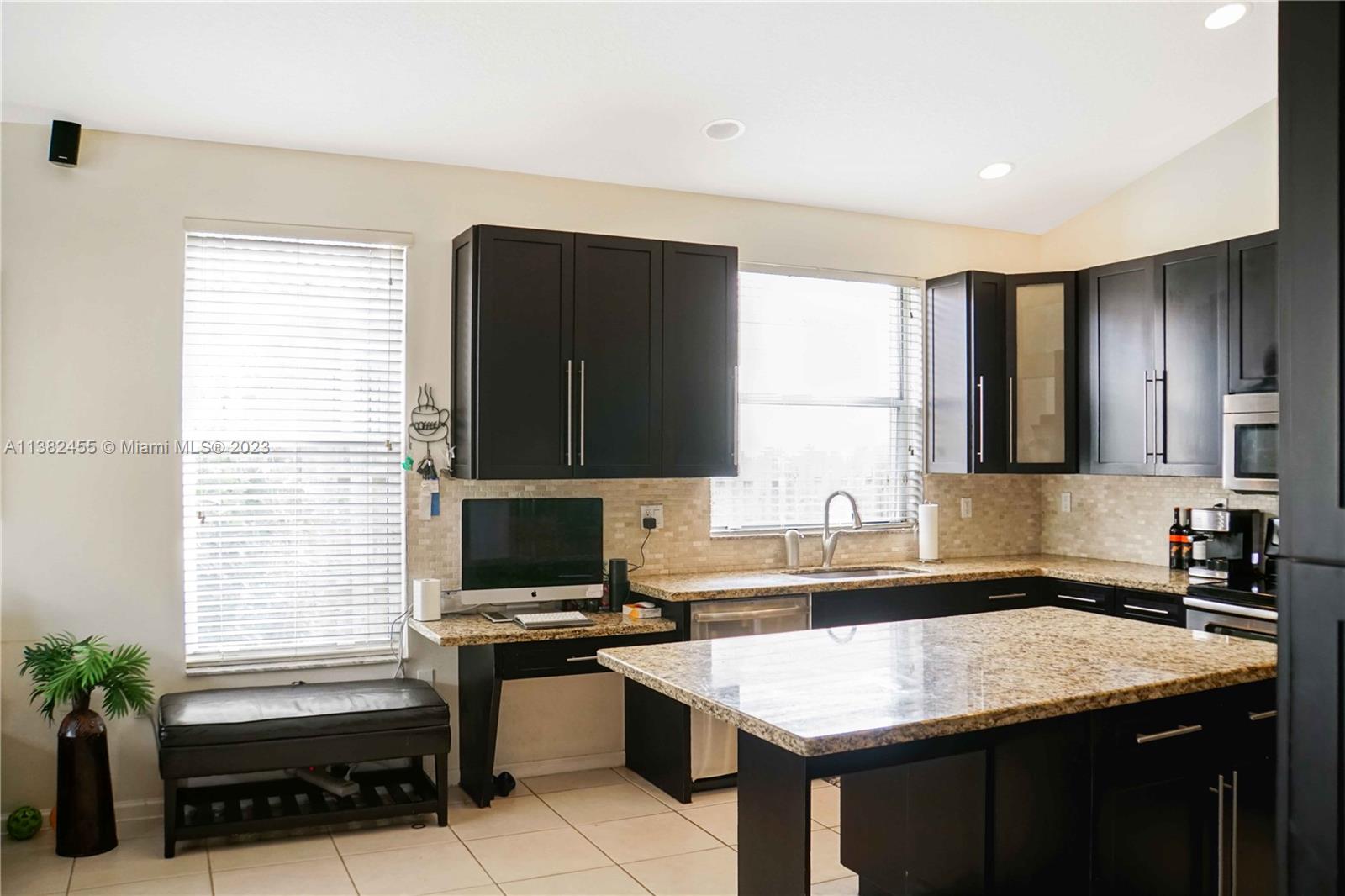 Miramar Miramar, FL 33029 - Photo 7 of 18 a kitchen with a sink stove and cabinets