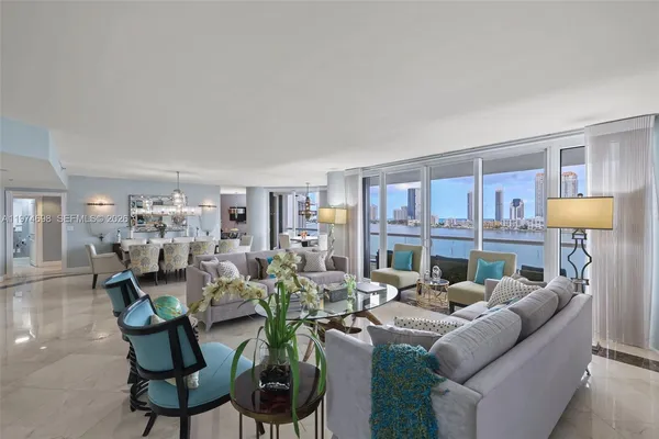 a living room with furniture and a kitchen area