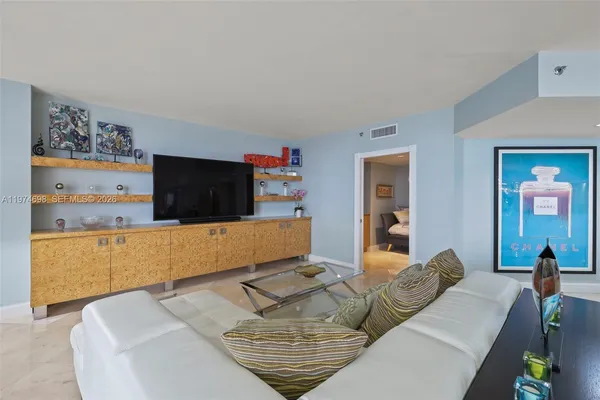 a living room with furniture and a flat screen tv