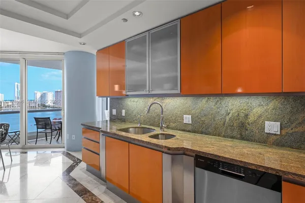 a kitchen with stainless steel appliances granite countertop a sink and cabinets