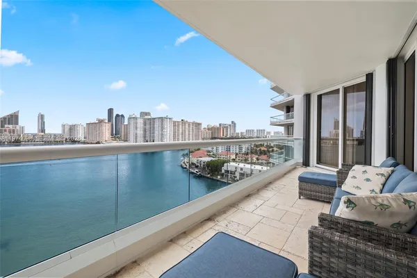 a living room with furniture and a balcony