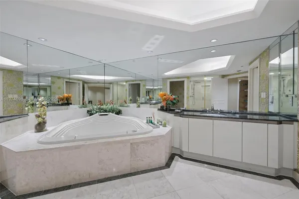 a large white kitchen with a large window