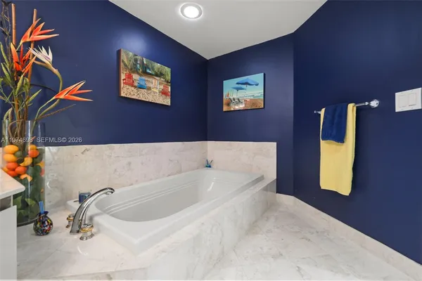 a bathroom with a tub and a potted plant