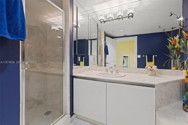 a bathroom with a shower sink and mirror