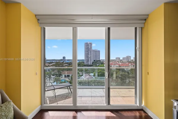 a view of a room with a large window and front door