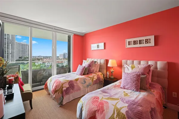 a bedroom with three beds and a large window