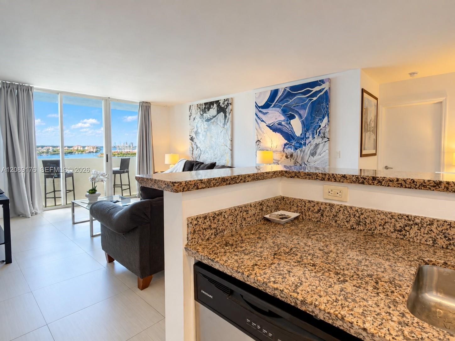 90 Alton Road, Unit 1710 Miami Beach, FL 33139 - Photo 8 of 16 Kitchen counter workspace overlooking the main living area