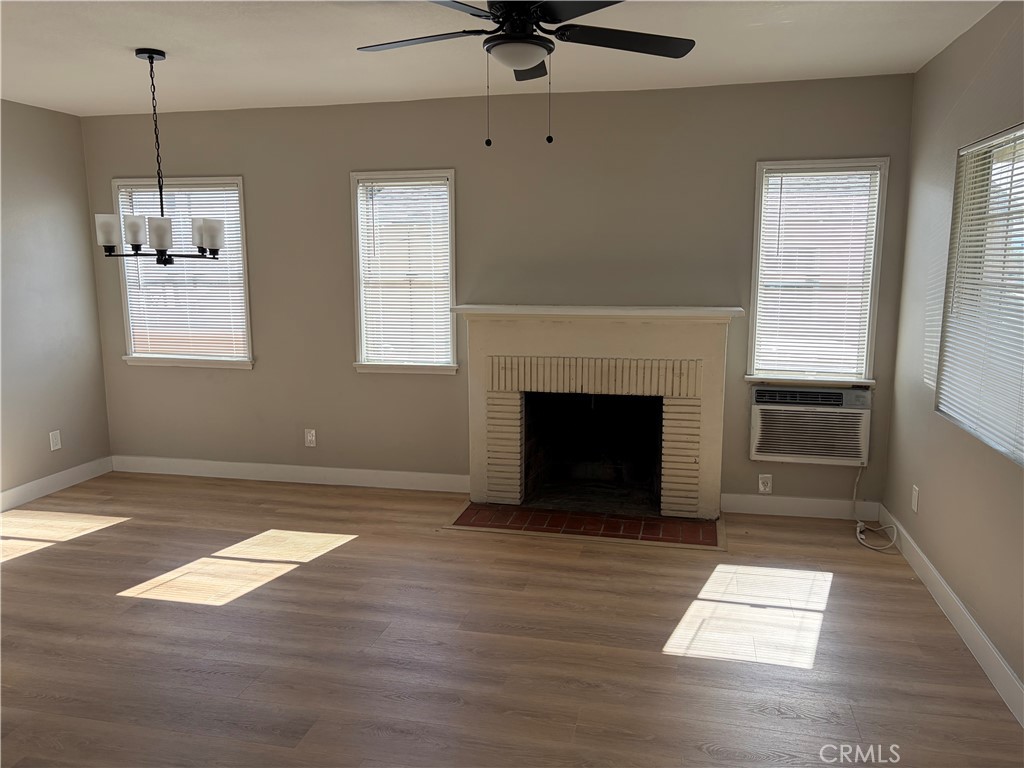1156 North Rancho Avenue Colton, CA 92324 - Photo 1 of 1 a view of empty room with wooden floor and fireplace
