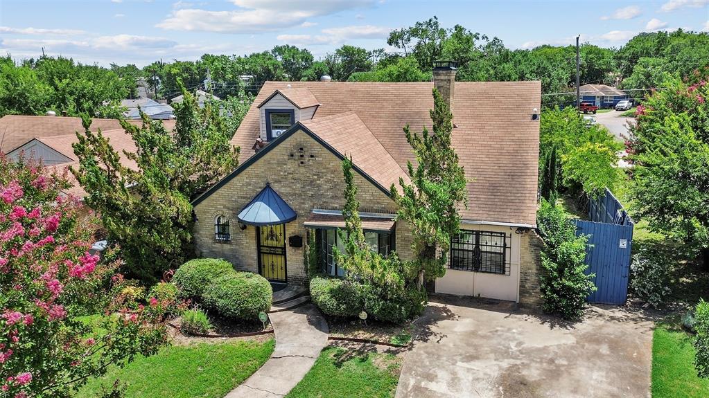 a aerial view of a house with a yard and potted plants