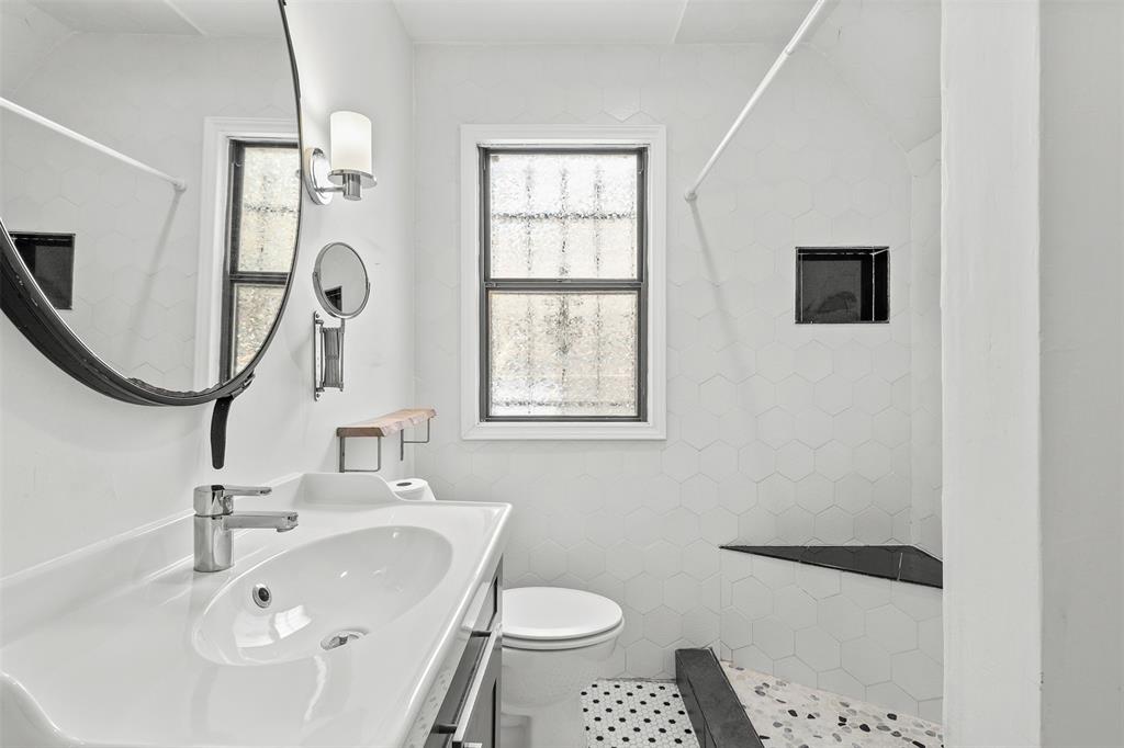 1902 Norfolk Avenue Dallas, TX 75203 - Photo 15 of 40 a bathroom with a sink a toilet and a mirror