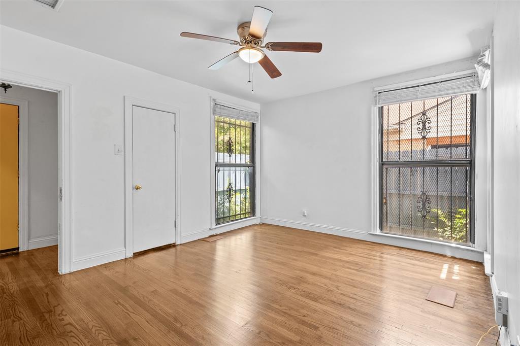 1902 Norfolk Avenue Dallas, TX 75203 - Photo 16 of 40 a view of an empty room with a window and wooden floor