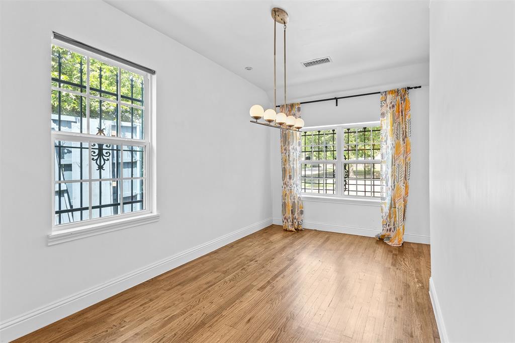 1902 Norfolk Avenue Dallas, TX 75203 - Photo 17 of 40 a view of an empty room with wooden floor and a window