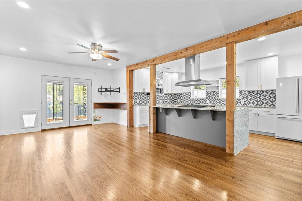 1902 Norfolk Avenue Dallas, TX 75203 - Photo 22 of 40 a view of an empty room with window and wooden floor