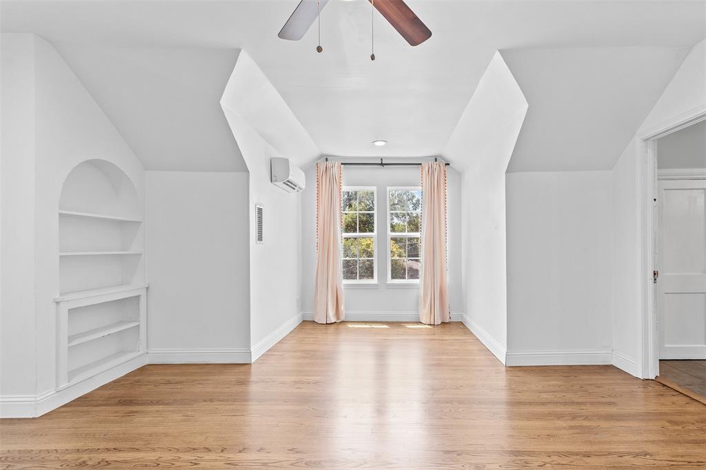 1902 Norfolk Avenue Dallas, TX 75203 - Photo 7 of 40 an empty room with wooden floor and windows