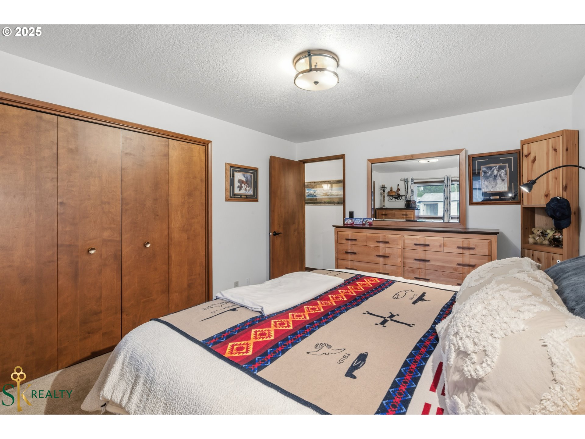 2555 Northwest Squire Place Albany, OR 97321 - Photo 25 of 44 a bedroom with a bed and a chandelier