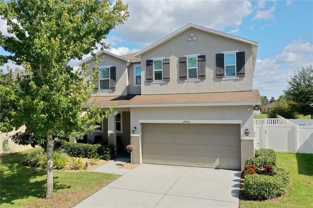 12418 Field Point Way Spring Hill, FL 34610 - Photo 1 of 1 a front view of a house with a yard and garage