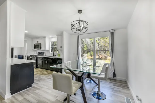 a view of a dining room with furniture window and wooden floor