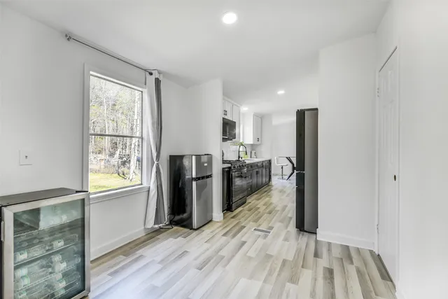 a view of a refrigerator in kitchen and wooden floor