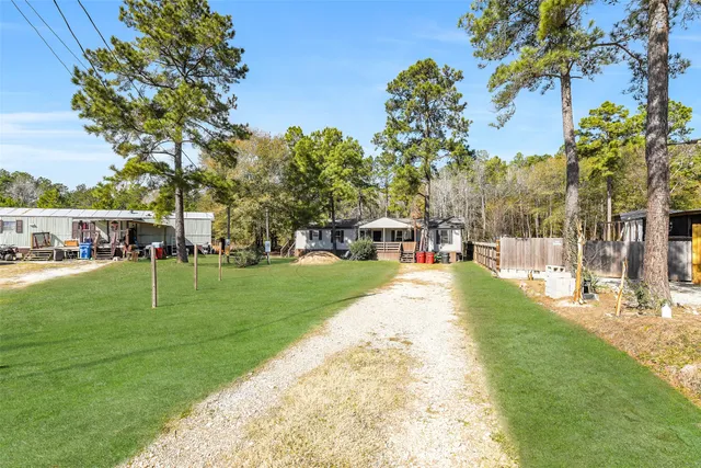a view of yard with swimming pool and trees