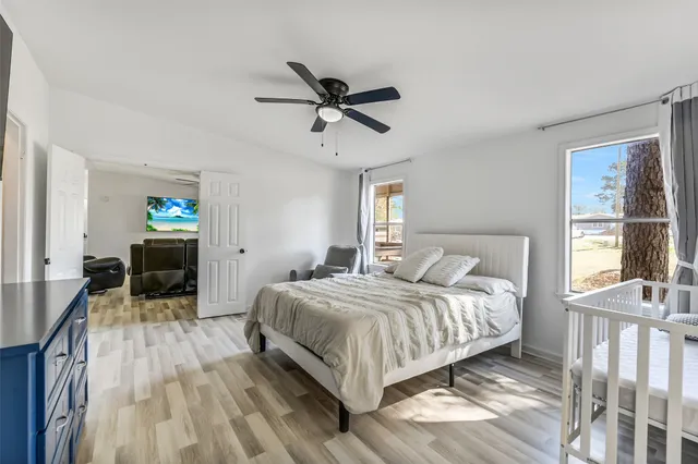 a bedroom with a bed and a chandelier