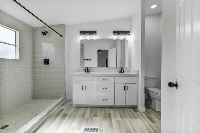 a bathroom with a sink a mirror and a shower