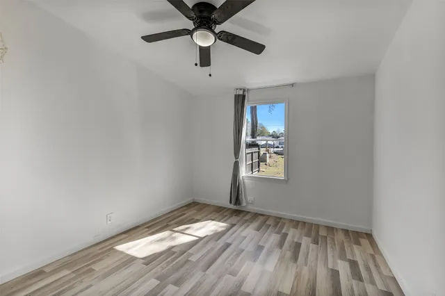 wooden floor in an empty room with a window