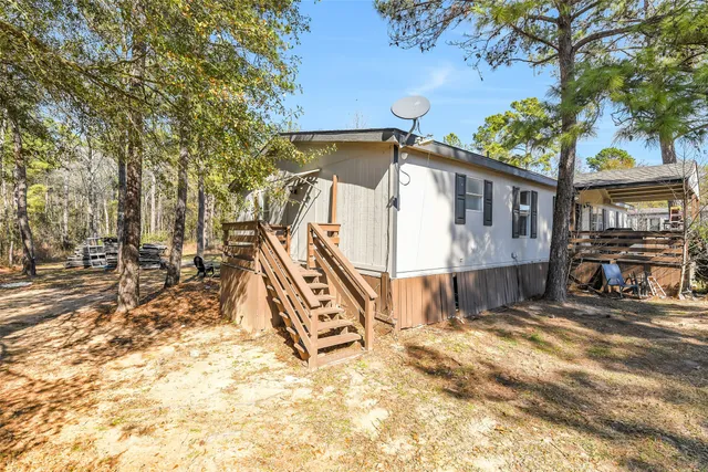 a view of a house with a yard and sitting area