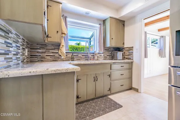 a kitchen with granite countertop a sink and cabinets