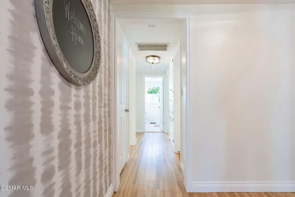 a view of bedroom with wooden floor