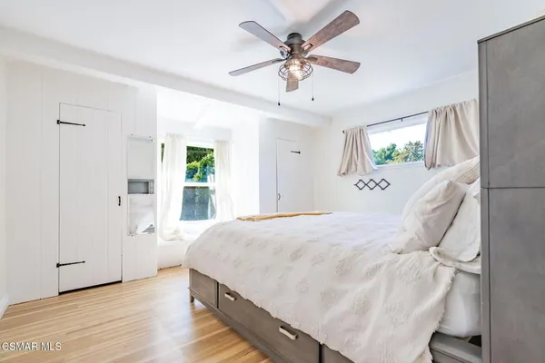 a bedroom with bed and a chandelier