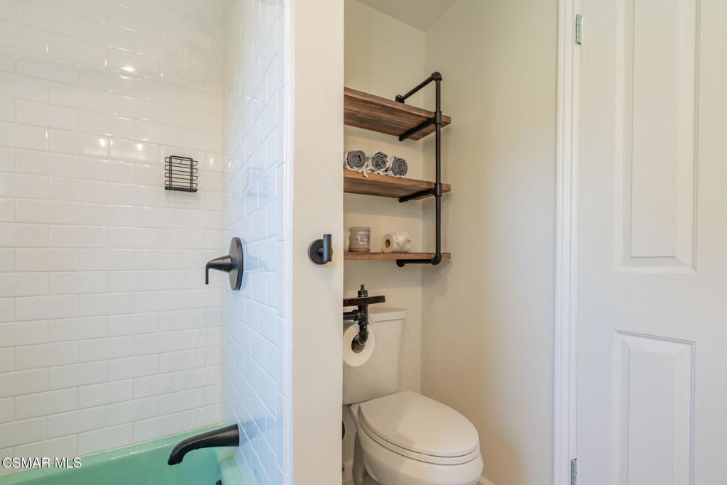 4310 Eve Road Simi Valley, CA 93063 - Photo 28 of 50 a white toilet sitting next to a shower