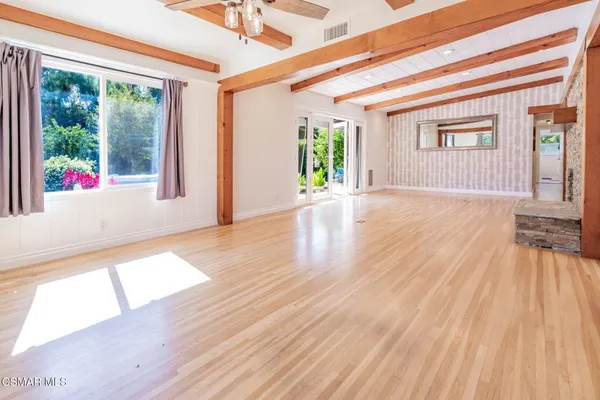 a view of an entryway with wooden floor and door