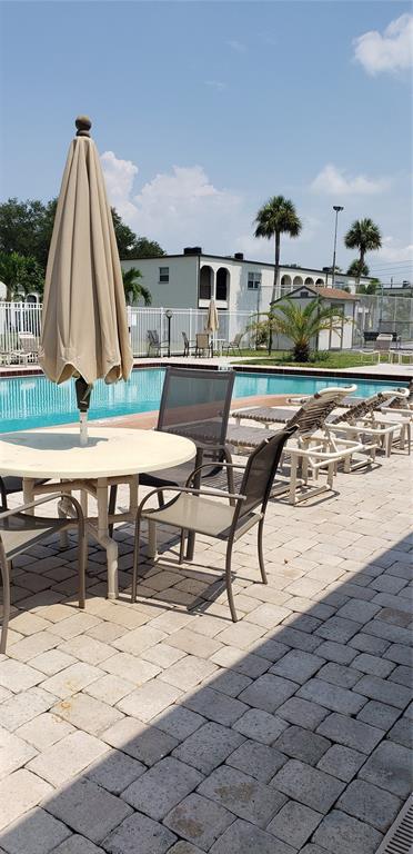7701 Starkey Road, Unit 102 Seminole, FL 33777 - Photo 17 of 24 a view of swimming pool with a lounge chair