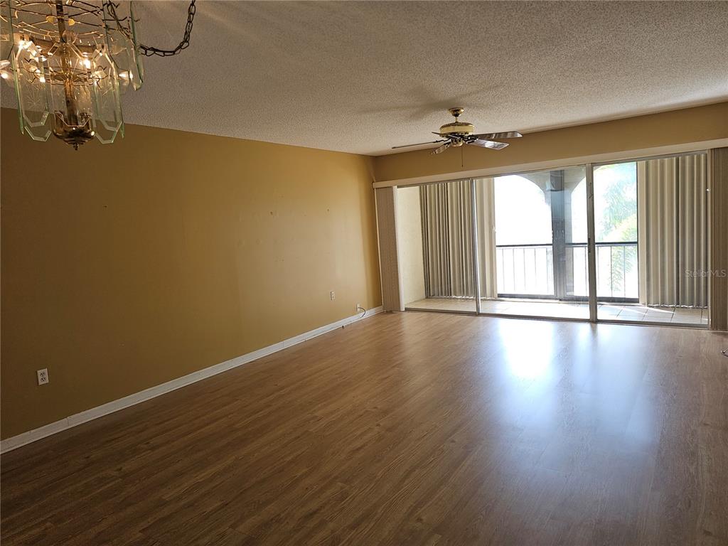 7701 Starkey Road, Unit 102 Seminole, FL 33777 - Photo 2 of 24 a view of livingroom with hardwood floor and ceiling fan