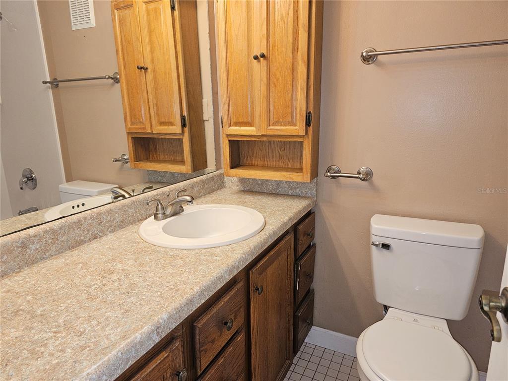 7701 Starkey Road, Unit 102 Seminole, FL 33777 - Photo 5 of 24 a bathroom with a granite countertop sink toilet and shower