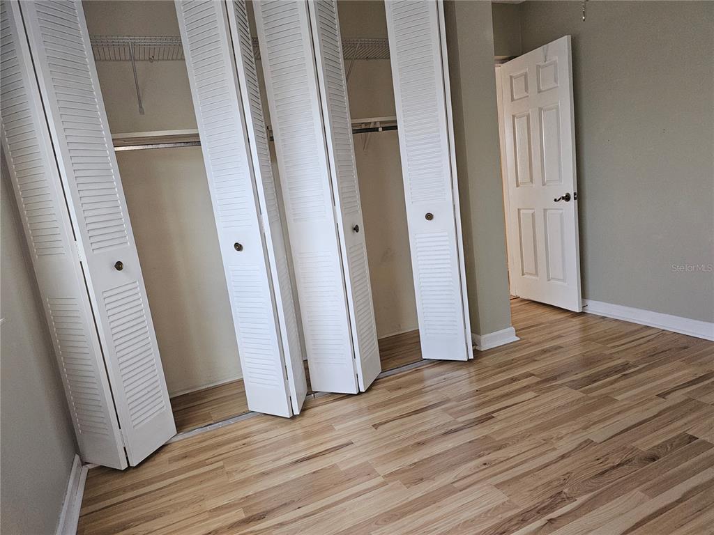 7701 Starkey Road, Unit 102 Seminole, FL 33777 - Photo 9 of 24 an empty room with wooden floor and entrance