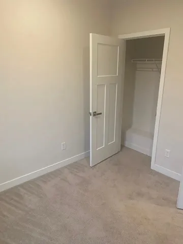 an empty room with closet area