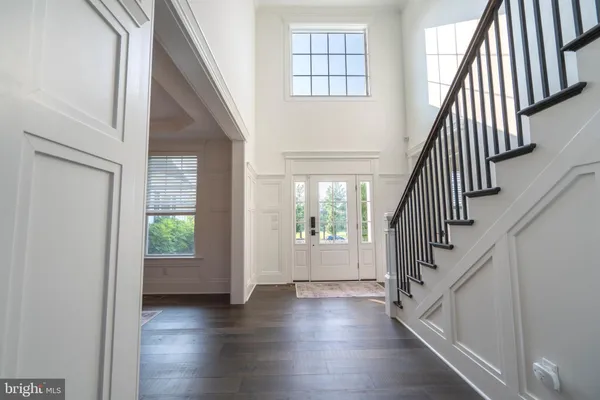 a dining room with furniture window and wooden floor