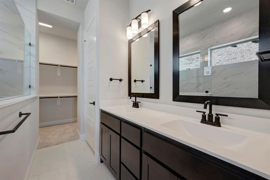 1857 Lightner Road Van Alstyne, TX 75495 - Photo 9 of 29 a bathroom with a double vanity sink a mirror and shower