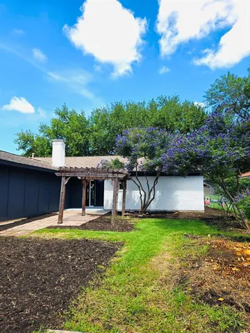 a view of a backyard with a garden and trees