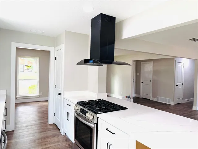 a kitchen with a stove and a refrigerator