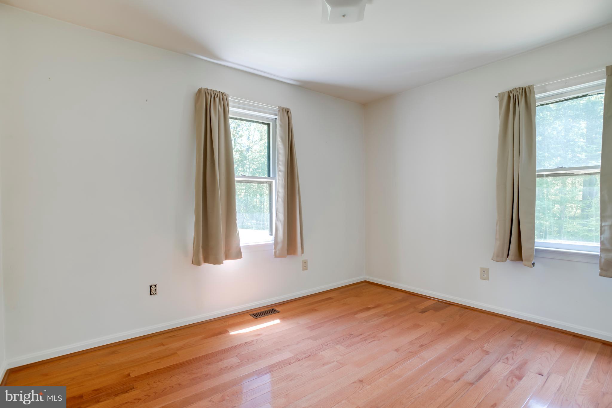 803 Weaver Hollow Road Banco, VA 22711 - Photo 11 of 67 an empty room with wooden floor and windows