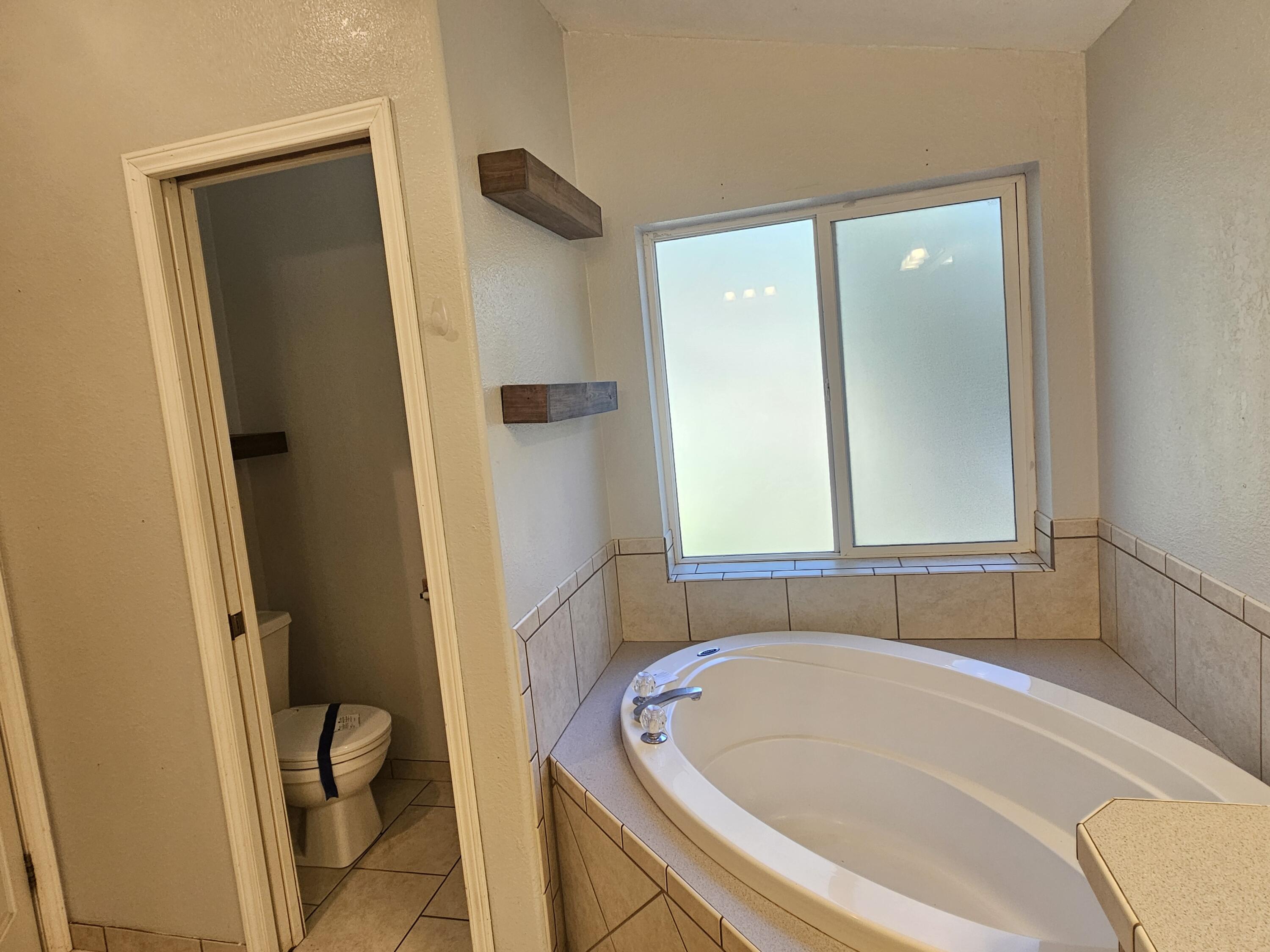 18015 Freight Rd Lane Klamath Falls, OR 97601 - Photo 11 of 24 a bathroom with a tub and a window