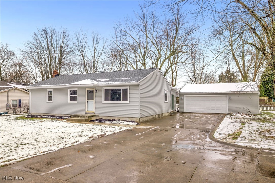 3930 Wadsworth Road Barberton, OH 44203 - Photo 2 of 30 Ranch-style home featuring a chimney, a garage, and a shingled roof