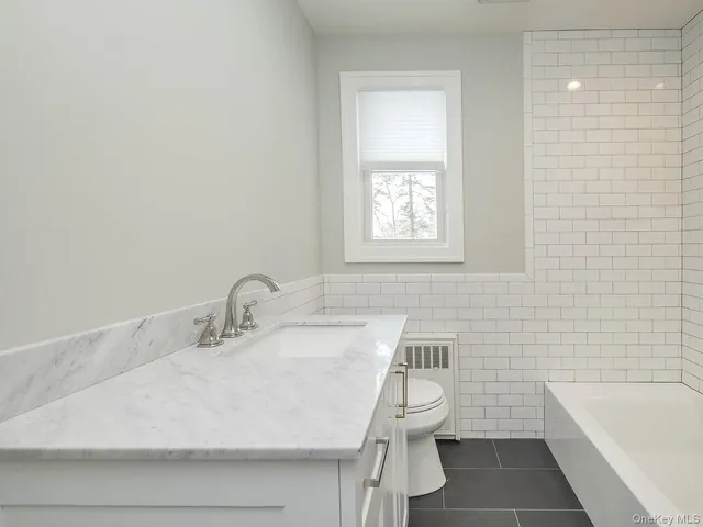 a bathroom with a sink a toilet and bathtub