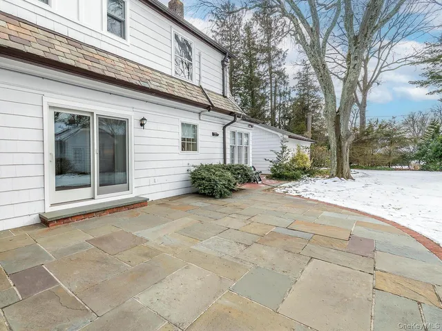 a white house with trees in front of it