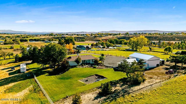 a living room with furniture a fireplace and a large window