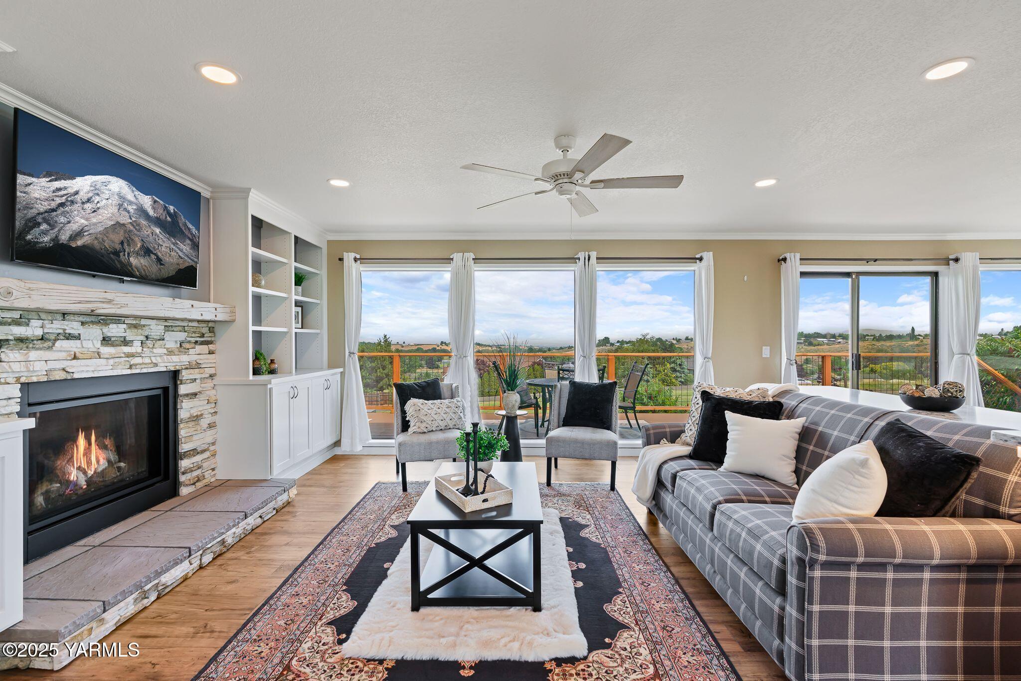 283 Cook Road Yakima, WA 98908 - Photo 14 of 64 a living room with furniture a fireplace and a large window