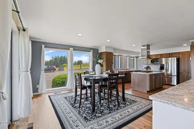 a view of a dining room with furniture window and wooden floor