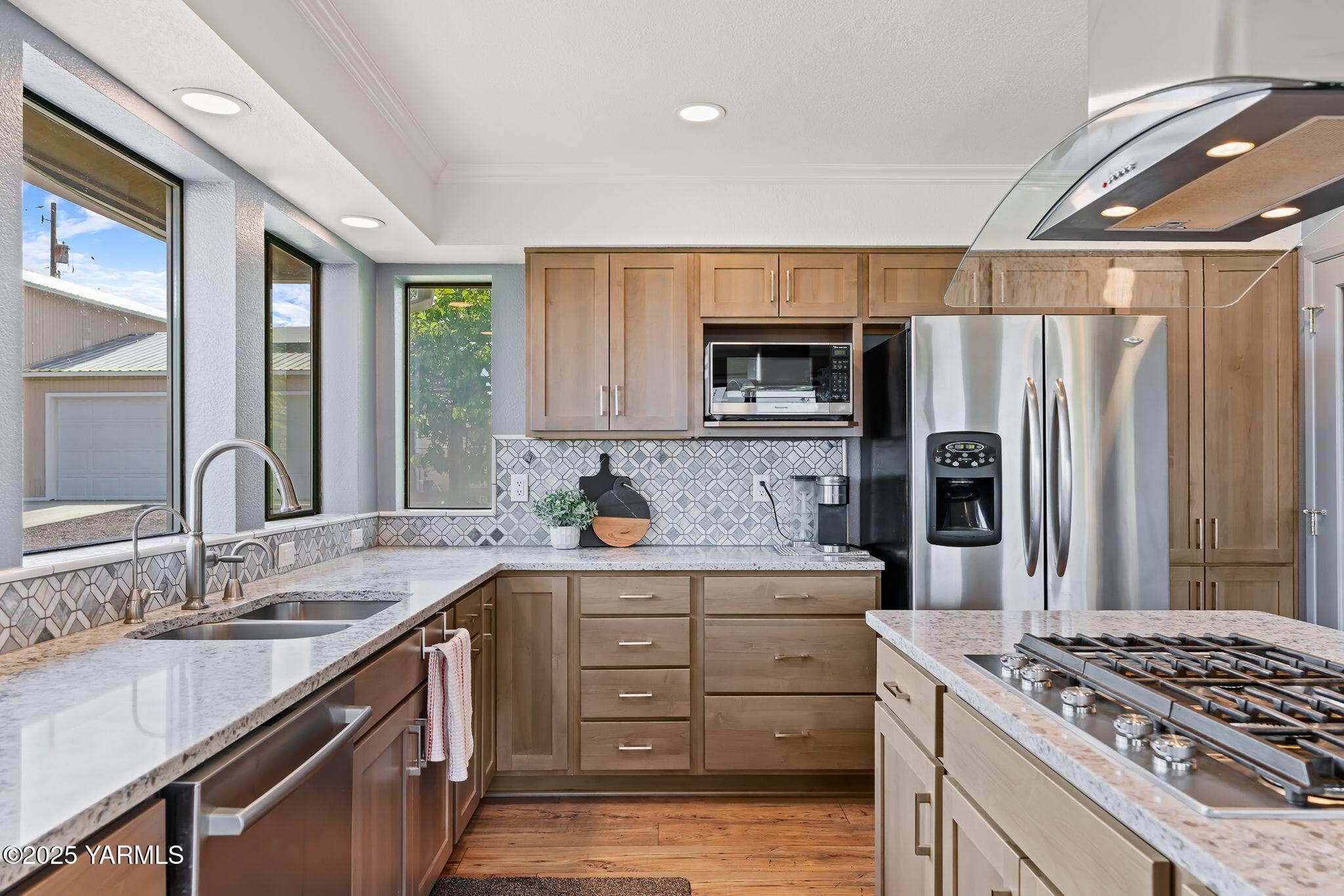 283 Cook Road Yakima, WA 98908 - Photo 22 of 64 a kitchen with stainless steel appliances granite countertop a sink stove and refrigerator